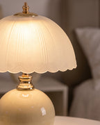 Close-up of the Petal Dome lamp's scalloped frosted glass shade and gold-finish neck