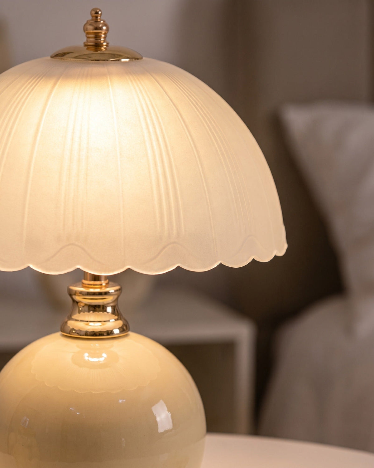 Close-up of the Petal Dome lamp's scalloped frosted glass shade and gold-finish neck