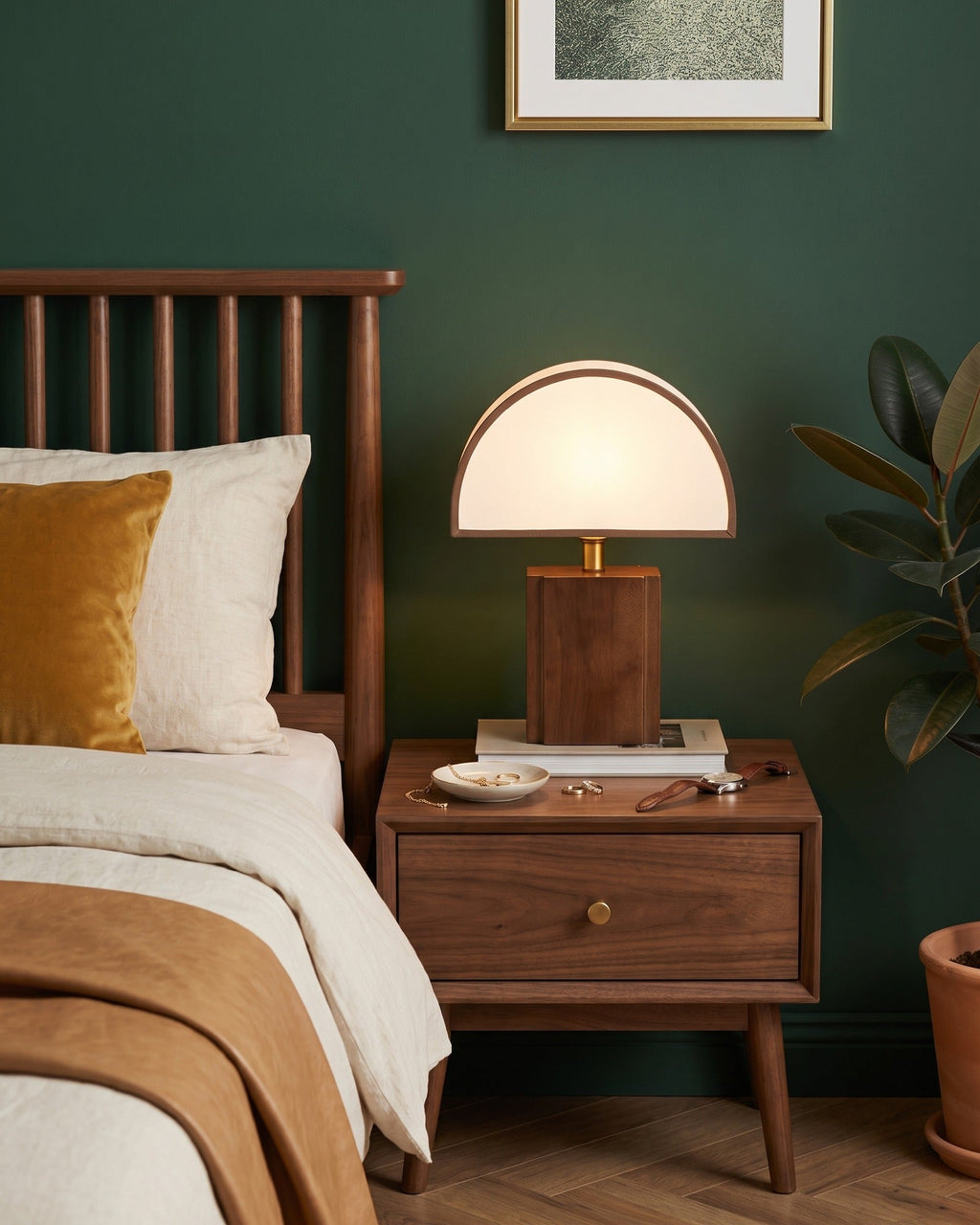 Halvo walnut nightstand lamp with a white half-dome shade against a dark green wall