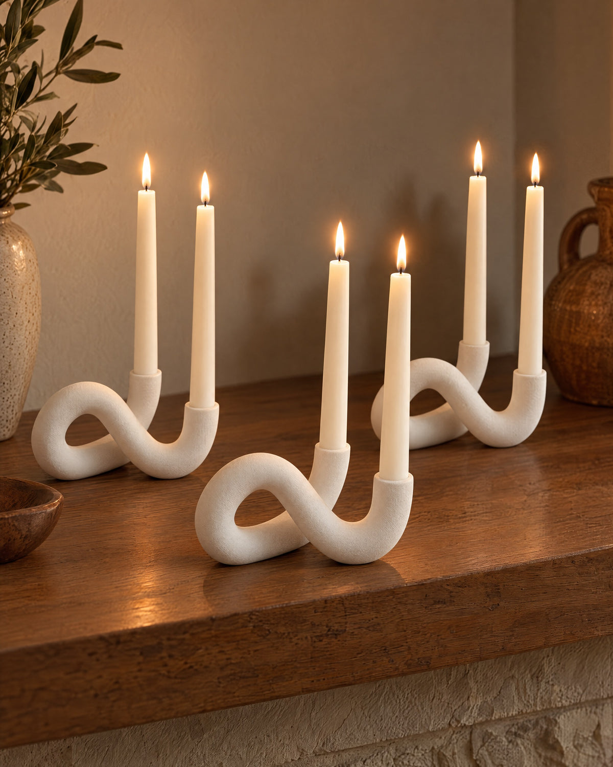 White: Knot Sculptural Double Candle Holder, three styled together with lit candles