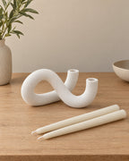 White: Knot Sculptural Double Candle Holder with the candle type that fits, shown beside it