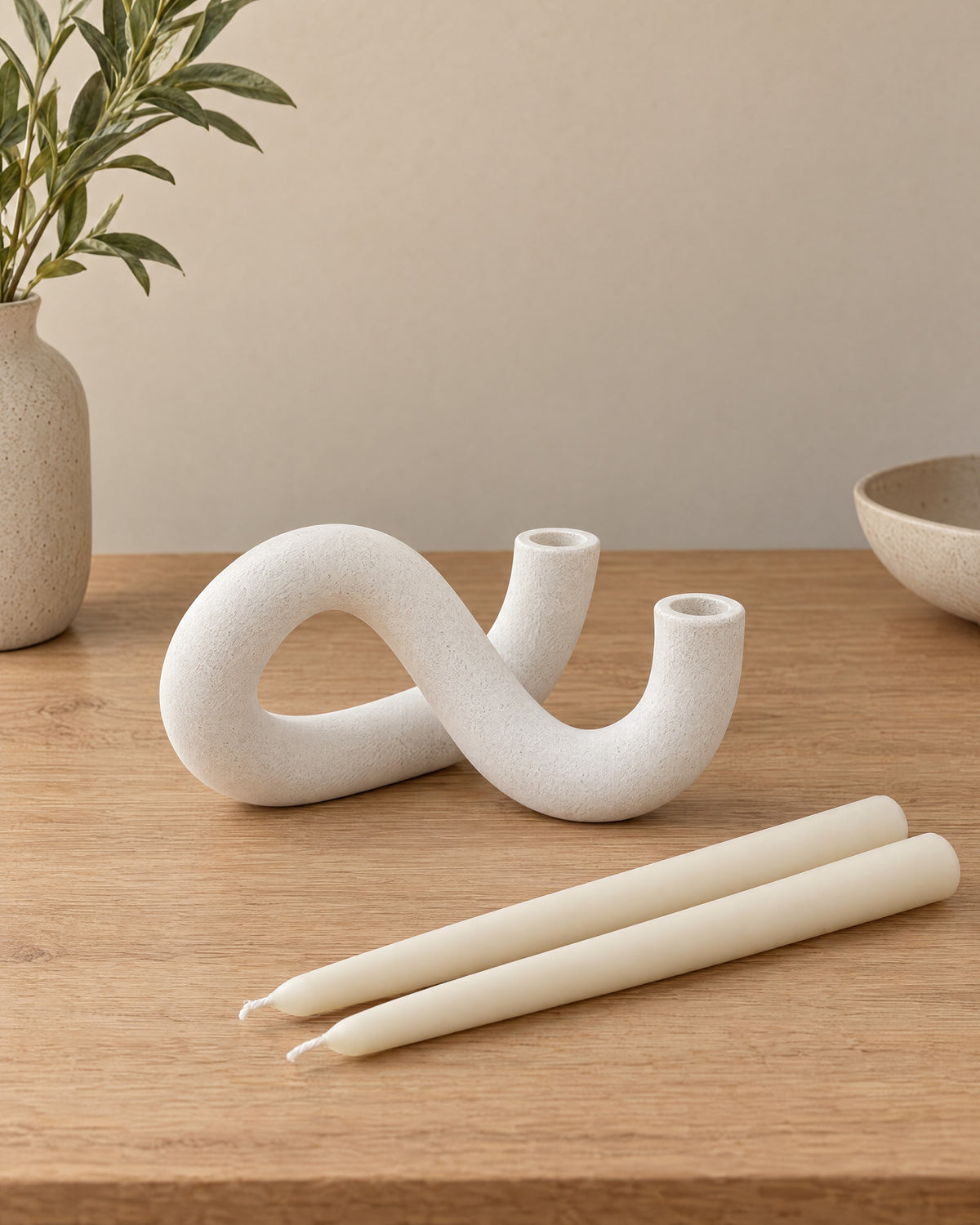 White: Knot Sculptural Double Candle Holder with the candle type that fits, shown beside it
