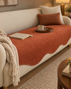 Rust Haze: All-Season Plain Contour Fit Sofa Cover on a cozy lived-in sofa