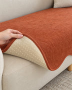 Rust Haze: Corner lifted to show the underside of the All-Season Plain Contour Fit Sofa Cover