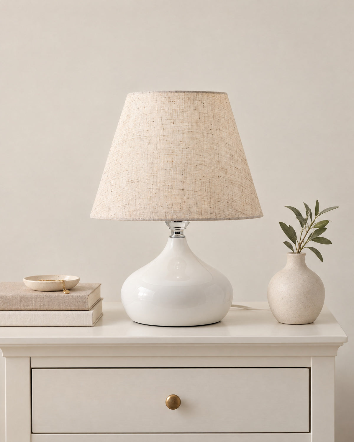 White: Aria Ceramic Nightstand Lamp in white on a nightstand top against a plain backdrop