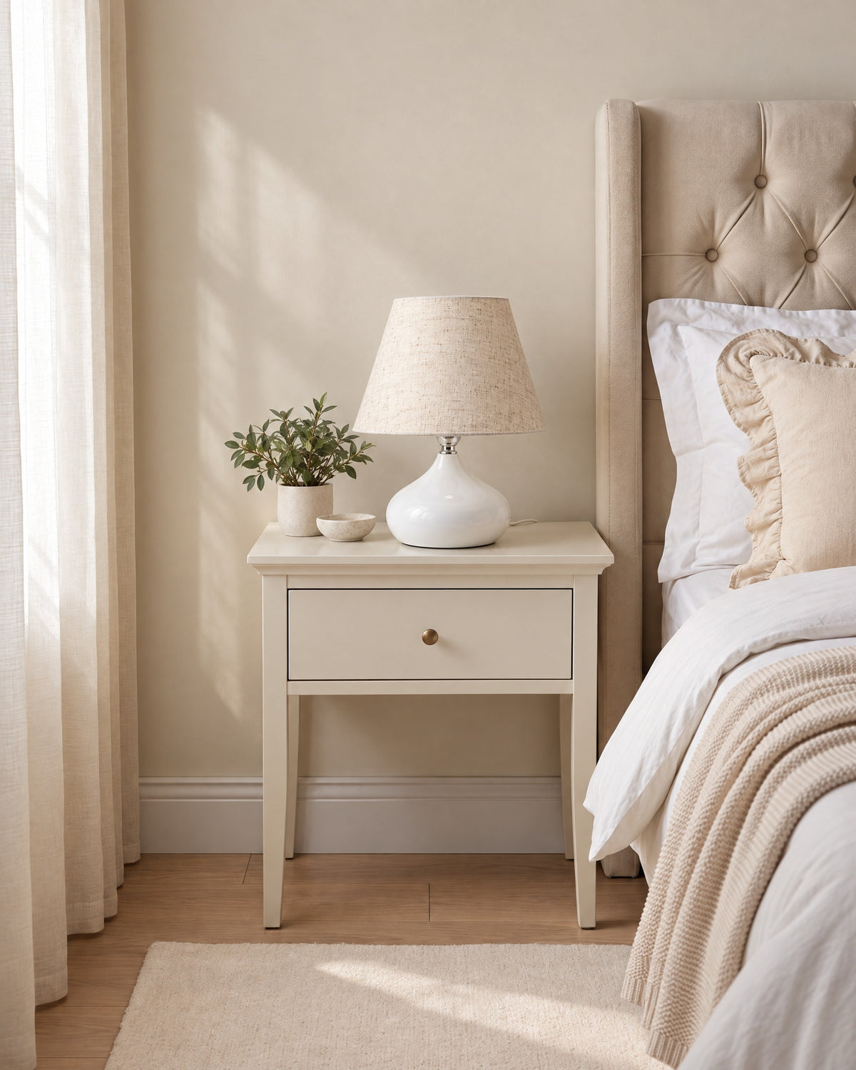 White: Aria Ceramic Nightstand Lamp in white switched off in soft morning light