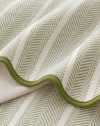 Sage Stripe: Close-up of the fabric and edge of the Aurivelle Herringbone Scallop Edge Sofa Cover