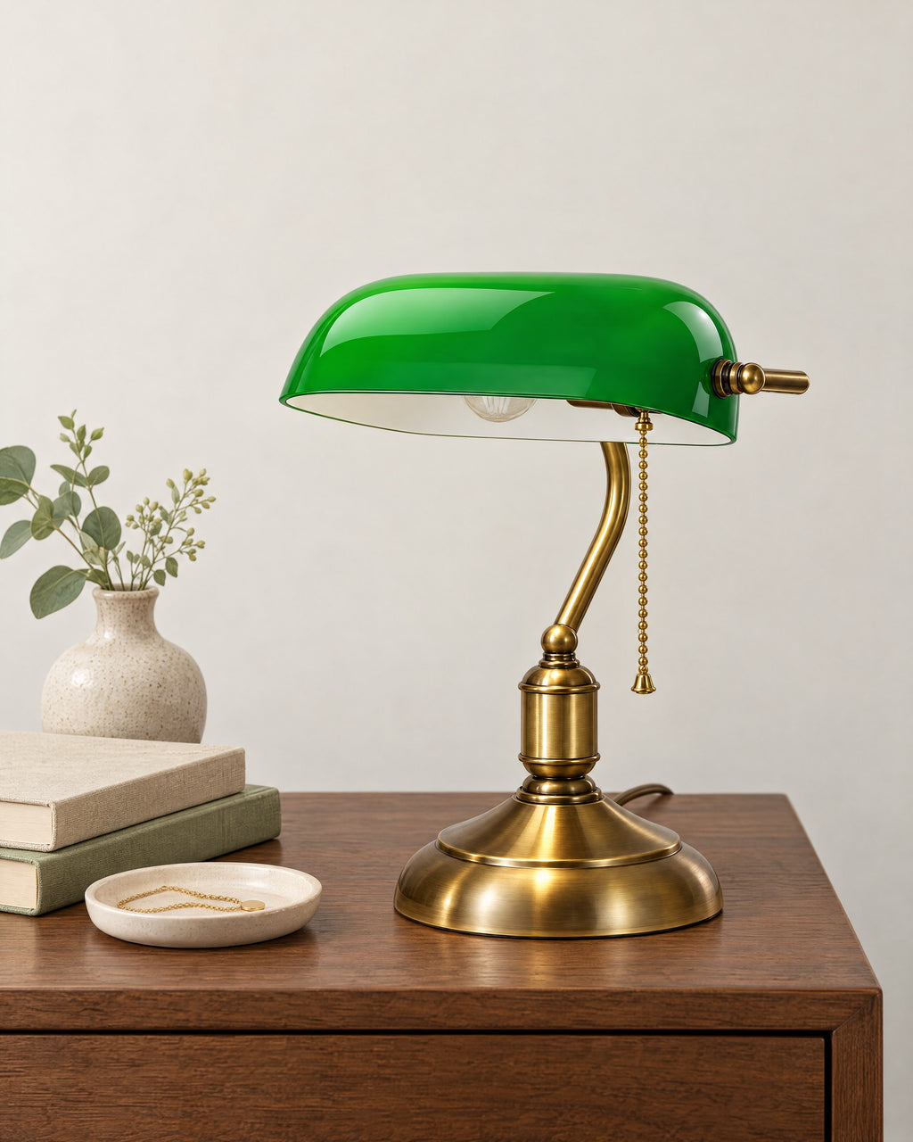 Bankers Green Glass Nightstand Lamp on a nightstand top against a light studio backdrop