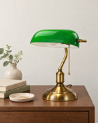 Bankers Green Glass Nightstand Lamp on a nightstand top against a light studio backdrop