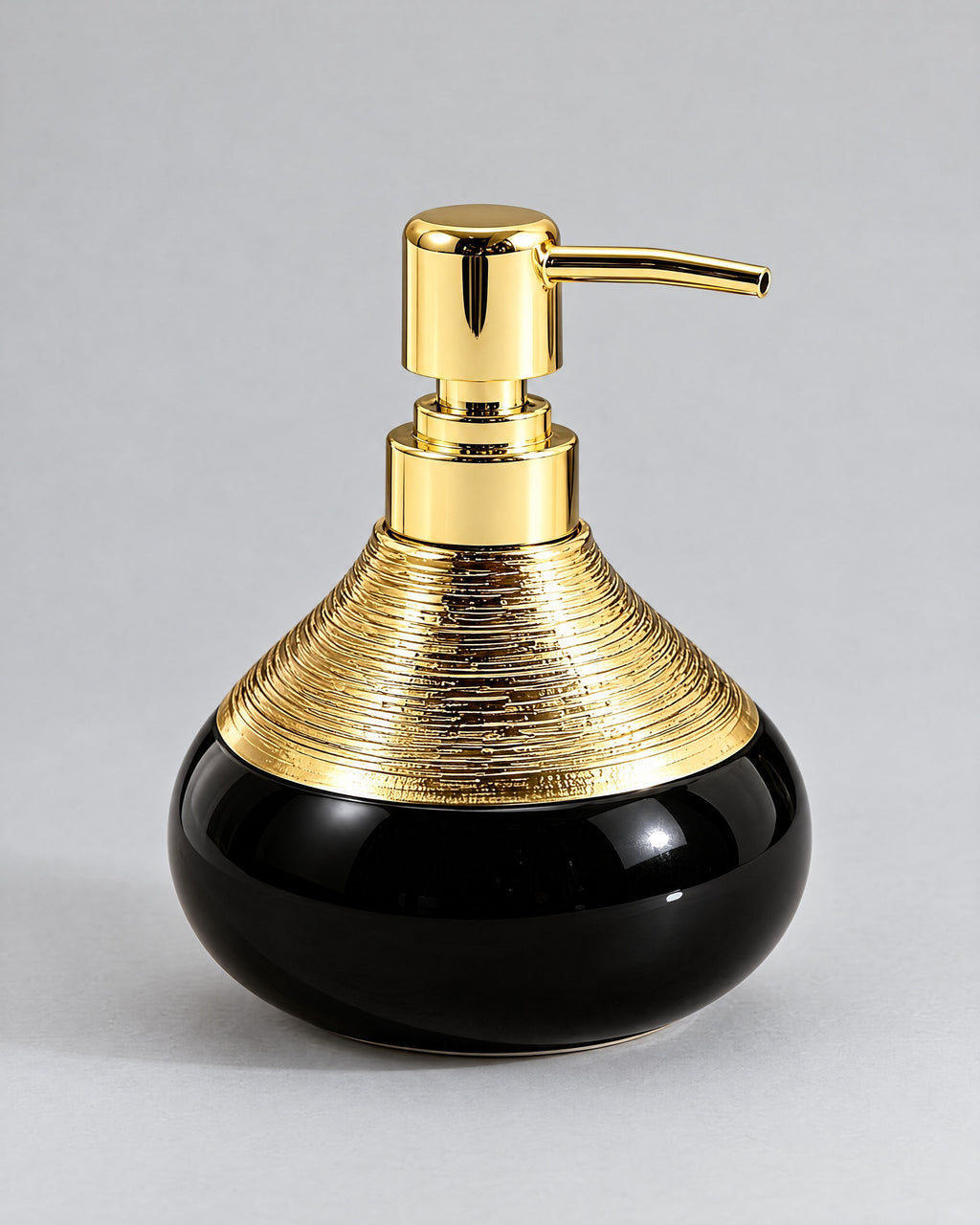 Soap Dispenser, Ceramic, Black with Brushed Gold, 9 oz against a seamless studio backdrop