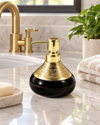 Soap Dispenser, Ceramic, Black with Brushed Gold, 9 oz styled on a bathroom counter