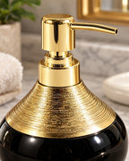 Close-up of the glaze and pump finish of the Soap Dispenser, Ceramic, Black with Brushed Gold, 9 oz