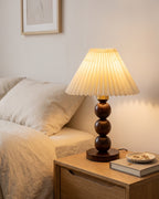 Walnut: Bobbin Trio Wood Nightstand Lamp in a cream minimalist bedroom