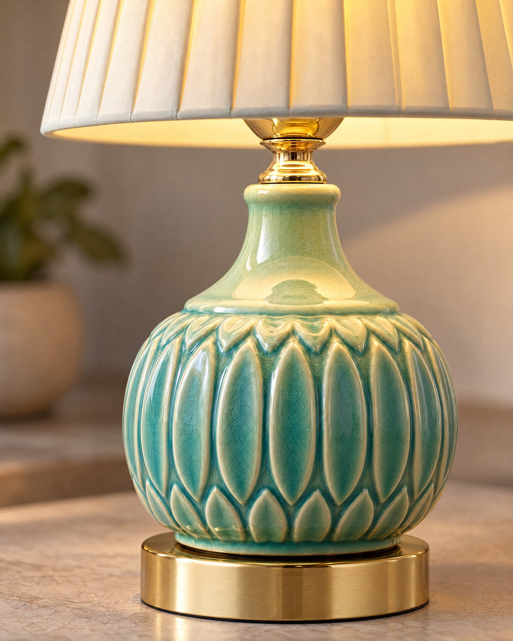 Close-up of the carved celadon crackle glaze and gold foot of the Celadon Carved Gourd Nightstand Lamp