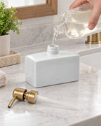 White: The Ceramic Soap Dispenser, Rectangular, Gold Pump, 13.5 oz being refilled, pump set aside