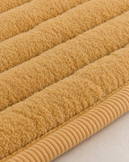 Honey Gold: Close-up of the fabric of the Chic Thick Plush Sofa Cover