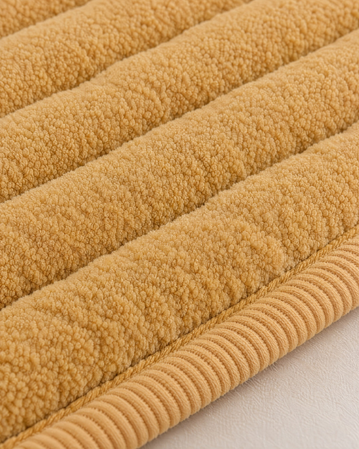 Honey Gold: Close-up of the fabric of the Chic Thick Plush Sofa Cover