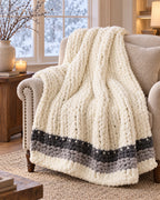 Chunky Knit Throw Blanket, Cream, Washable Feather Yarn draped over an armchair by a winter window
