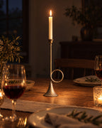 Tall (15.9 in): Corno Horn Ring Iron Candlestick with candles lit at night on a dinner table