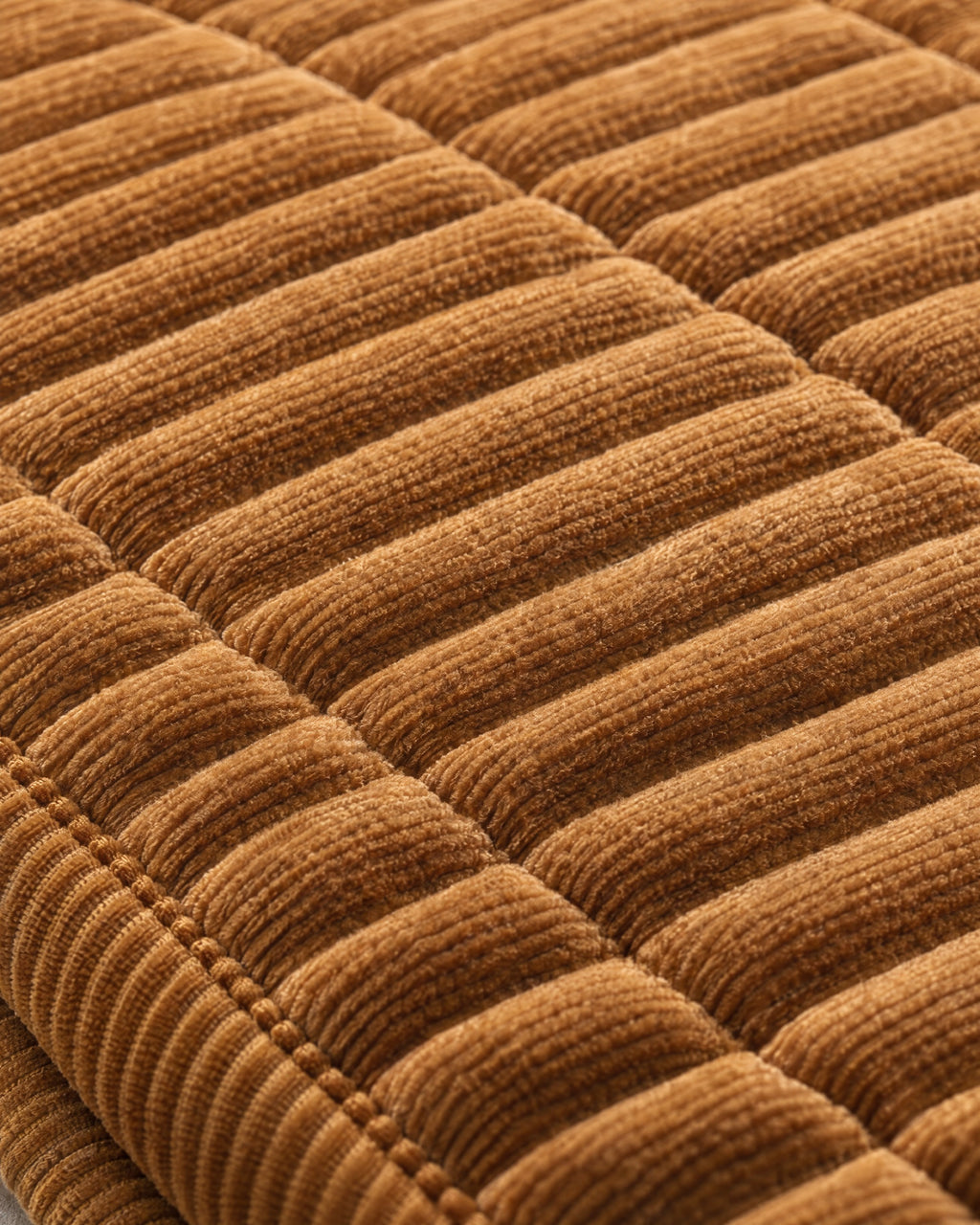 Golden Amber: Close-up of the fabric of the Cozy Quilted Couch Cover Protector