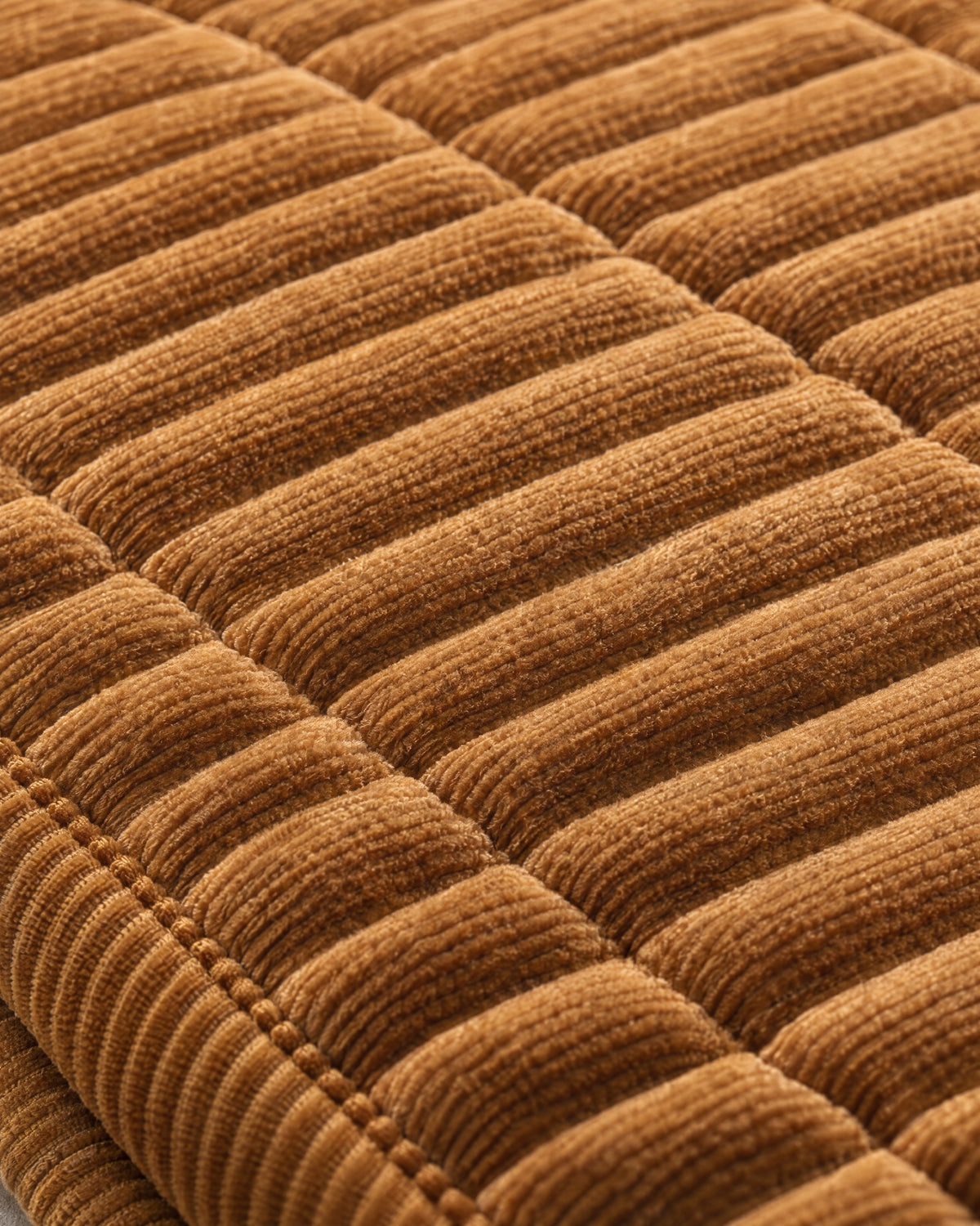Golden Amber: Close-up of the fabric of the Cozy Quilted Couch Cover Protector