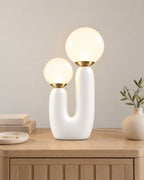 White: Duo Globe Sculptural Nightstand Lamp on a nightstand top against a light studio backdrop