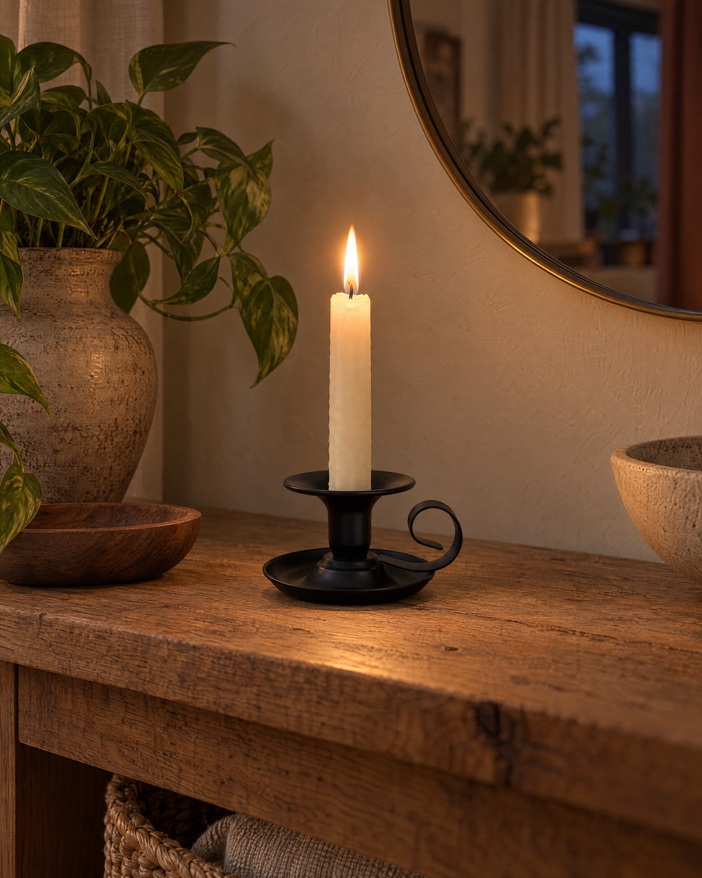 Tazza Iron Teacup Candle Holder styled in a warm interior at dusk