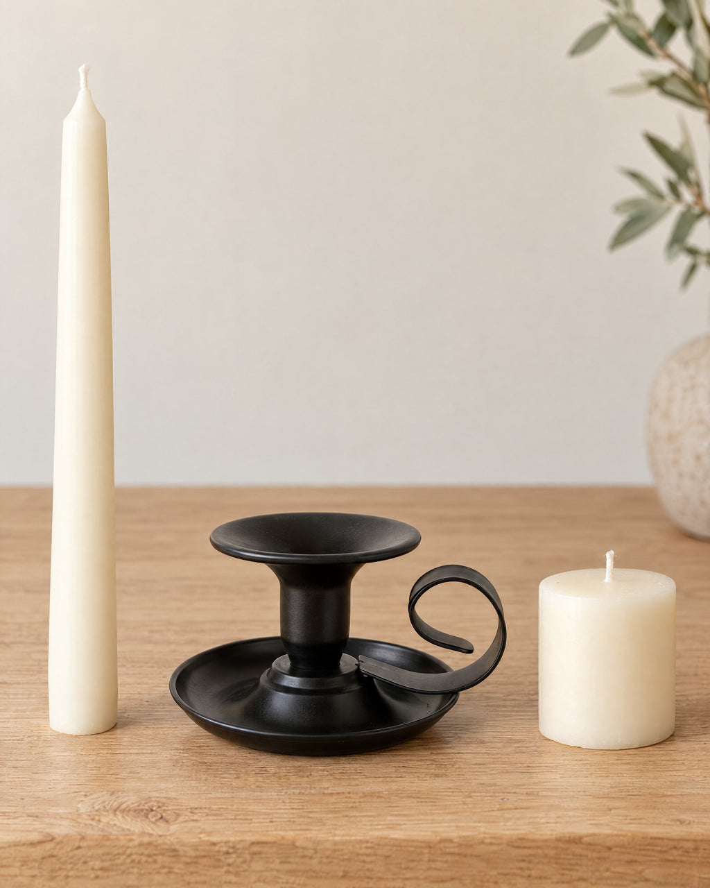 Tazza Iron Teacup Candle Holder with the candle type that fits, shown beside it