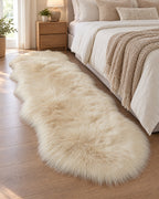 Cream: The longer 3.3 x 6.6 ft size of the Faux Sheepskin Rug, Cream, 2.8 in Fluffy Pile as a bedside runner