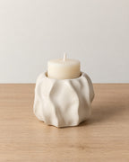 Low & Wide: Wave Abstract Ceramic Candle Holder on a light oak tabletop against a seamless studio backdrop