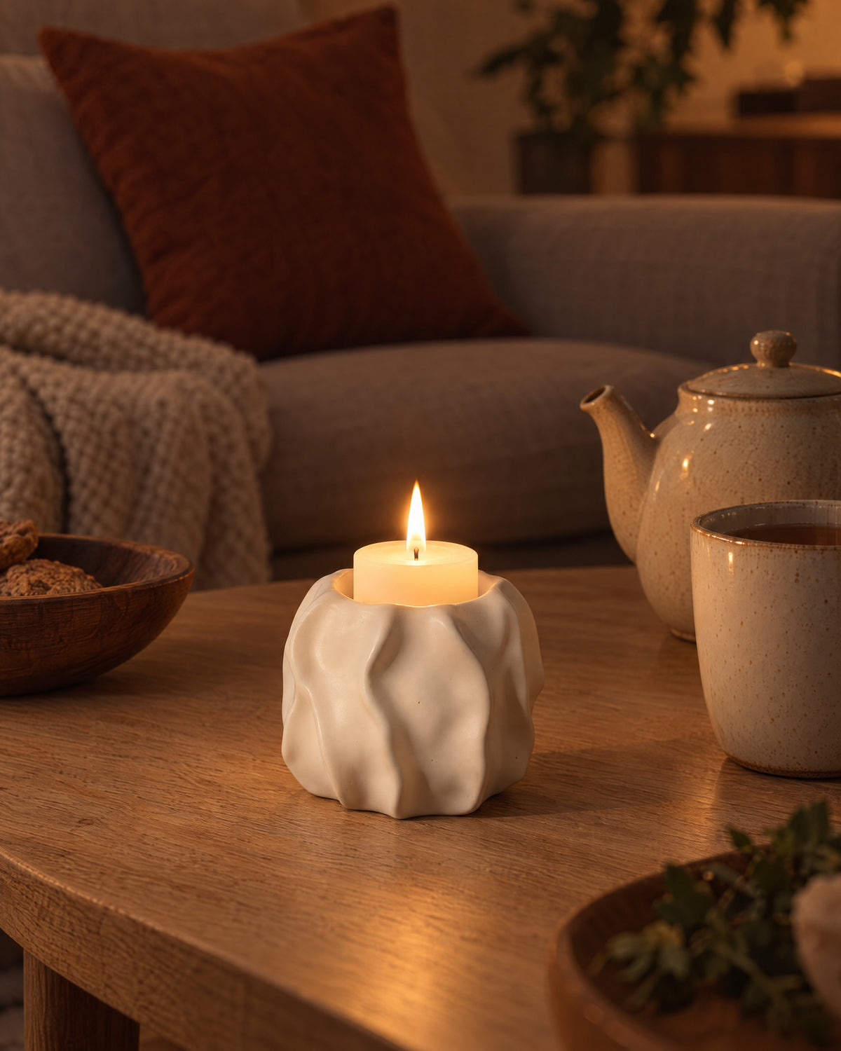 Low & Wide: Wave Abstract Ceramic Candle Holder, lit, in a lived-in evening scene