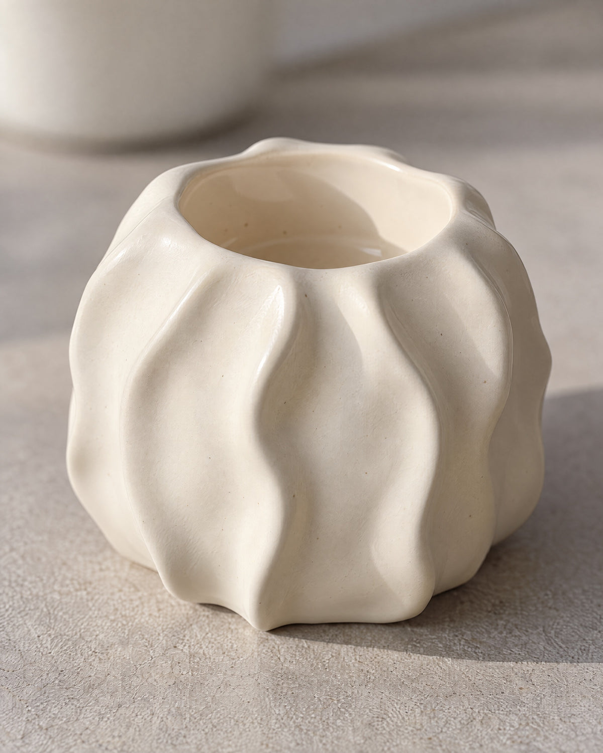 Low & Wide: Close-up of the material and finish of the Wave Abstract Ceramic Candle Holder