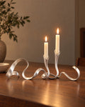 Silver: Ribbon Metal Candelabra, lit, on a styled surface in the evening