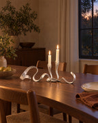Silver: Ribbon Metal Candelabra styled in a warm interior at dusk