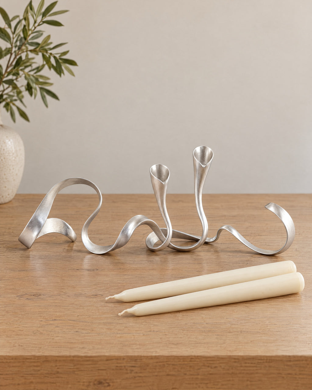 Silver: Ribbon Metal Candelabra with the candle type that fits, shown beside it