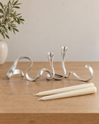 Silver: Ribbon Metal Candelabra with the candle type that fits, shown beside it