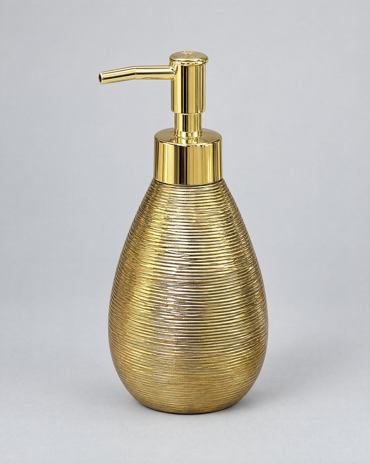 Teardrop Soap Dispenser, Ceramic, Brushed Gold against a seamless studio backdrop