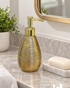 Teardrop Soap Dispenser, Ceramic, Brushed Gold shown at true scale on a countertop