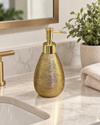 Teardrop Soap Dispenser, Ceramic, Brushed Gold styled on a bathroom counter
