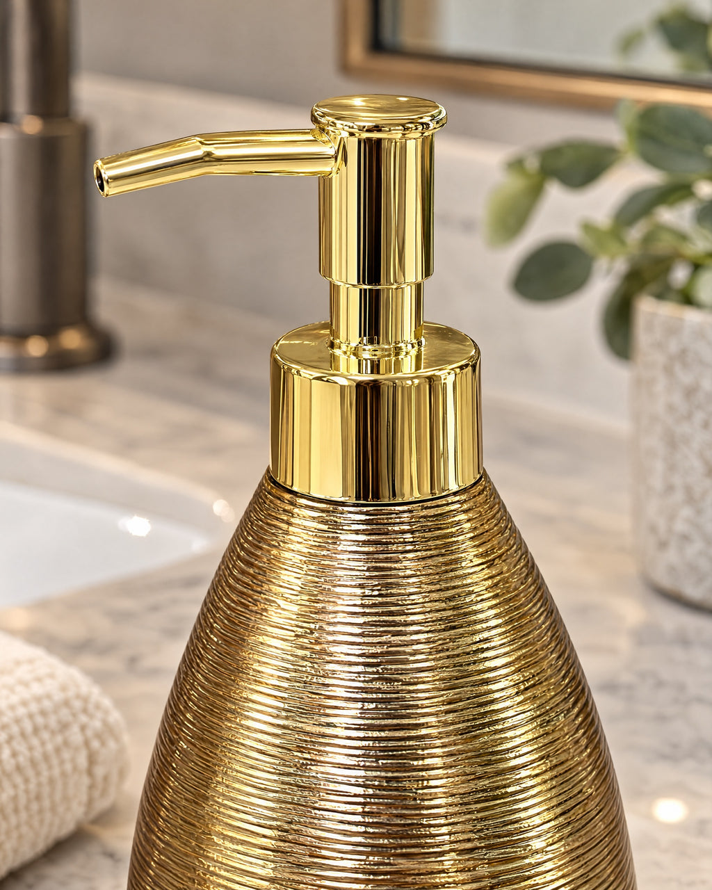Close-up of the glaze and pump finish of the Teardrop Soap Dispenser, Ceramic, Brushed Gold