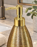 Close-up of the glaze and pump finish of the Teardrop Soap Dispenser, Ceramic, Brushed Gold