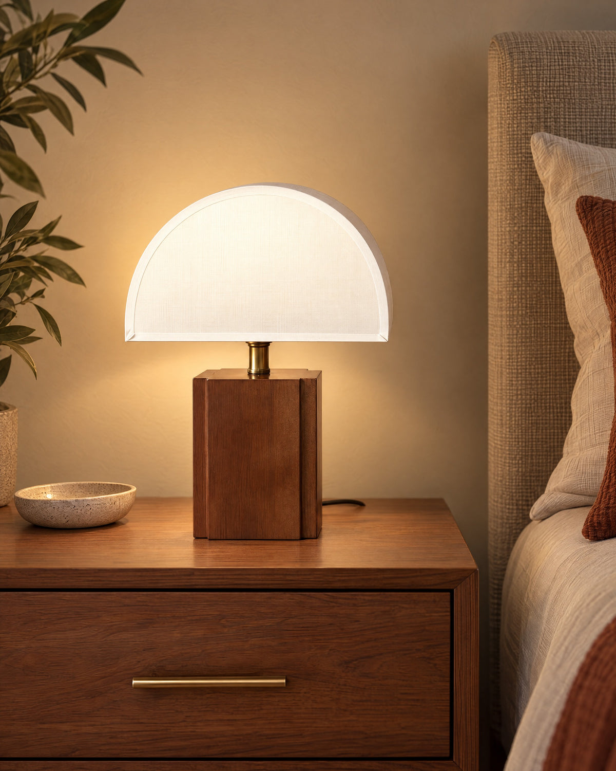 White Trim: Halvo Half Dome Walnut Nightstand Lamp in walnut / white trim lit on a nightstand in the evening