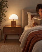 White Trim: Halvo Half Dome Walnut Nightstand Lamp in walnut / white trim as a reading light beside a woman reading in bed