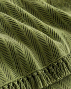 Green: Close-up of the fabric of the Herringbone Chenille Tassels Sofa Cover