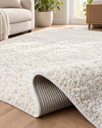 Ivory: Corner folded back to show the woven backing of the Ivory Shag Area Rug, 1.1 in Plush Pile