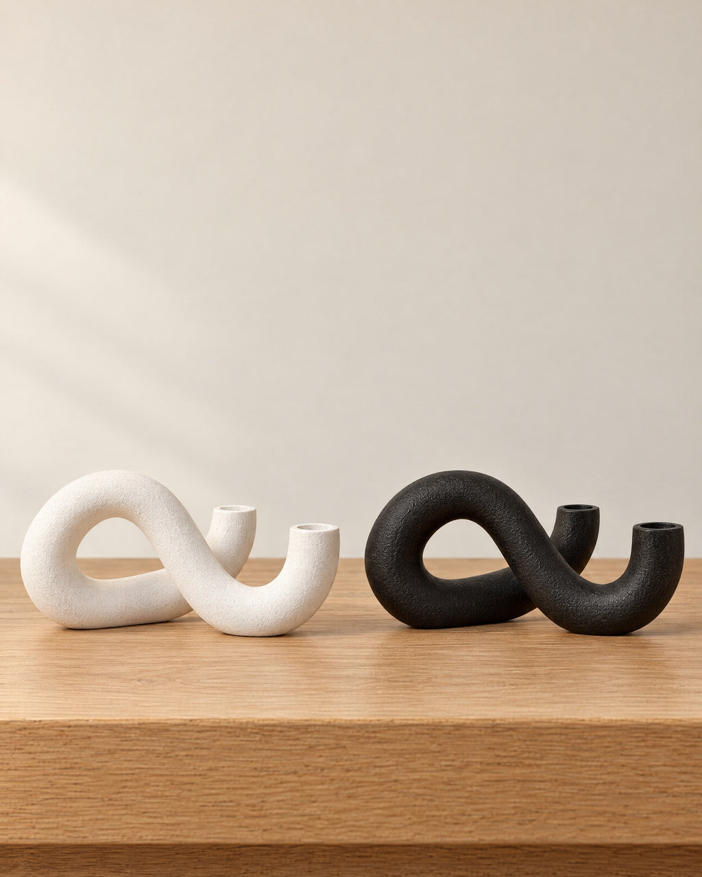 All colourways of the Knot Sculptural Double Candle Holder side by side: White, Black