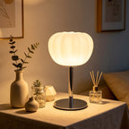 Luna ribbed opal glass lamp on a polished chrome stem on a side table