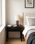 Linnea walnut nightstand lamp by a window in a bright bedroom