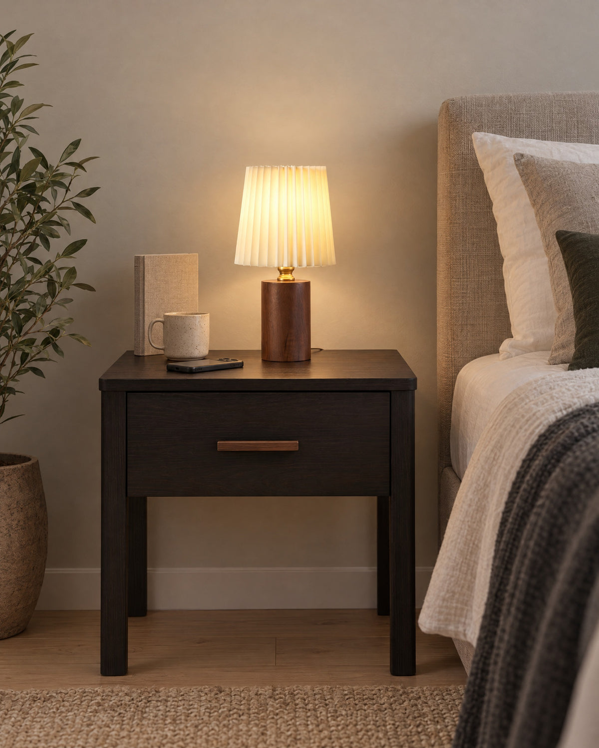 Walnut: Linnea Pleated Wood Nightstand Lamp in walnut on a standard nightstand, showing its true size