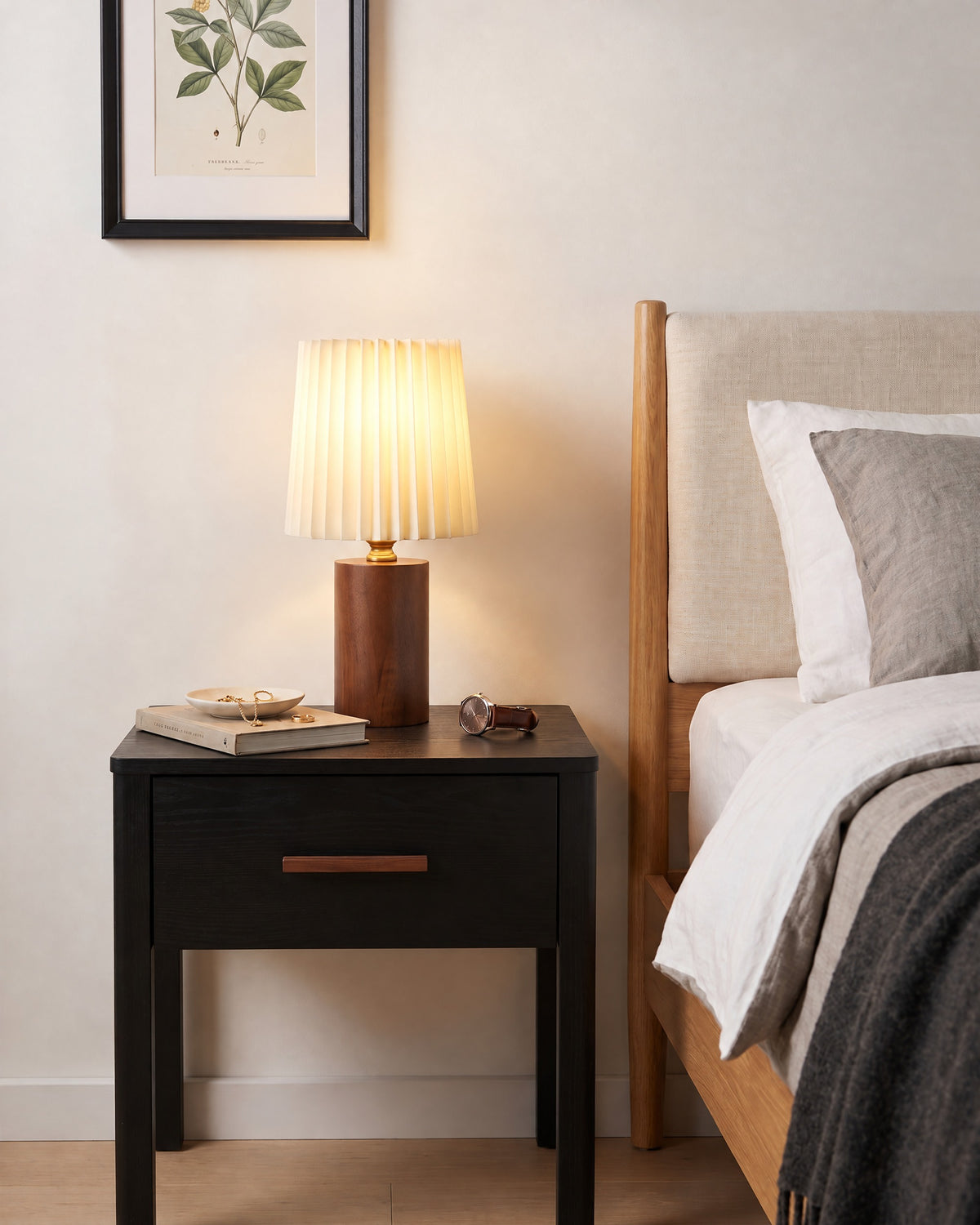 Walnut: Linnea walnut nightstand lamp with a pleated shade on a black nightstand